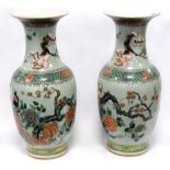 Pair of Japanese vases, each with flared rims and decorated with blossom and peacocks, 44cm high.