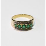 Half hoop ring with five graduated emeralds within a border of mixed-cut diamonds, in gold, '14k',