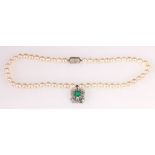 Cultured pearl choker necklet with diamond and emerald drop with baguettes and brilliants in gold.