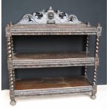 Jacobean style carved oak buffet with floral and lion mask cornice over three rectangular tiers,