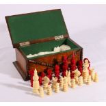 Carved and part stained Indian ivory chess set, complete, contained in an oak box, King 8.5cm.