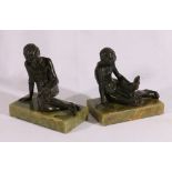 Pair of bronzed statues of a young man reading a book mounted on onyx bases as bookends,