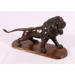 Japanese bronze model of a lion with inset glass eyes, wooden base, signed to base, 45cm.