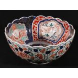 Imari deep bowl decorated with birds and decorative borders on a gilt blue ground.