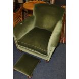 Victorian mahogany lounge chair on turned supports and a matched footstool, upholstered in green.