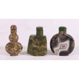 Three Chinese hardstone snuff bottles including one with painted gilt landscape, all c1980's,