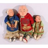 Three Chinese dolls c1920's with wood and straw filled cloth bodies wearing traditional dress with