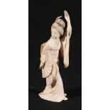 Japanese carved ivory figure of a geisha dancing, with a fan in one hand and a flower in the other,