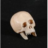 Japanese carved ivory skull, pierced for threading, 3cm,