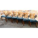 Set of six walnut dining chairs each with shaped top rail, horizontal splats,