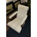 Victorian mahogany open armchair raised on turned feet and castors, in cream upholstery.