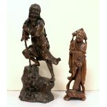 Japanese Meiji period bronzed spelter figure of a deity with emaciated ribs standing on a rock,