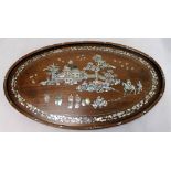 Oriental hardwood oval tray or panel with Mother of Pearl inlay depicting figures in a landscape