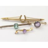 Gold horseshoe brooch, two others, amethyst and another '9ct'.