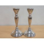 Pair of silver table candlesticks with Celtic borders, Reid & Son '1963', 9.5cm, loaded.