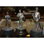 Three unhallmarked white metal statuettes, one of a cricketer, footballer and a rugby player,