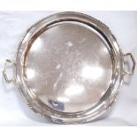 Silver circular tray of Art Deco style with zig-zag moulded border and handles by Brook & Sons