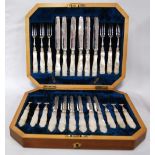 Set of twelve silver dessert knives and twelve forks, engraved, with pearl handles,