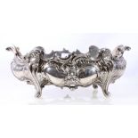 German silver dessert dish, oval with embossed swirls, scrolls and masks.