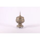 Burmese silver cup and cover with embossed figure and deities and other motifs upon detachable base,