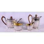 Silver four piece tea service comprising teapot, hot water pot, sugar and cream.