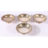 Set of four Edwardian silver pedestal butter dishes with scroll borders, London 1905,