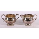 Elizabeth II silver sugar bowl and cream jug, Birmingham 1964, makers Walker and Hall, 398g.