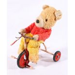 Mid 20th century model of Rupert The Bear type bear on a trike,