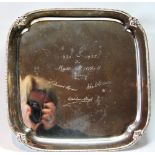 Silver square waiter with facsimile signatures, scroll feet, 1937, 24cm, 20oz.