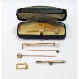 Pearl scarf pin, cased, three others, gem-set, a riding crop pin and a watch strap buckle, '9ct'.