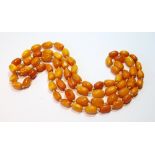 Amber bead necklace of slightly graduated ovoid beads, 61g.