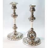 Pair of silver table candlesticks with embossed knopped baluster stems, on similar circular bases,