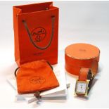 Hermès rolled gold fashion watch, ref. 3065711, with bag, a box and manual.