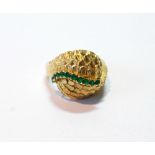 Gold dress ring of textured scales with a wavy line of emeralds, '.750', size L, 7.8g.