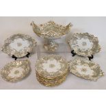 Early 19th century English porcelain dessert service with gilt foliate scrolling on grey ground,