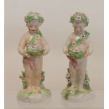 Pair of late 18th century Derby porcelain figures of putti with floral garlands,