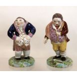 Two 19th century Derby porcelain figures of potbellied hunchback gentlemen,