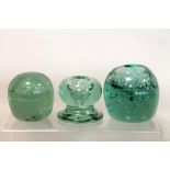 Green glass dump type paperweight of ovoid form, 8cm high; a similar inkwell or vase, 7.