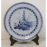 18th century Delft tin glazed circular plate with Chinese style landscape panel surrounded by