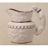 Small 19th century white glazed pottery jug with moulded hunting scene,