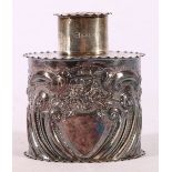Victorian silver tea cannister decorated in relief with C scrolls and floral motifs,
