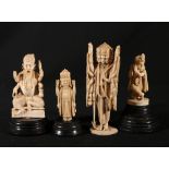 Four Indian early 20th Century carved ivory figures of deities and a Guru, 8cm to 13.