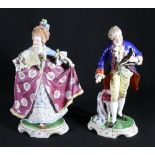 Pair of Continental porcelain figures modelled as a male holding a bicorn at a dressing stool and a