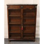 Regency style mahogany bookcase, the faux marble top above moulded frieze,