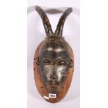 African carved wooden mask, with horns and prominent mouth, scarified face, 45cm possibly Baule,