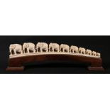 Early 20th Century Indian ivory bridge of elephants on a wooden stand, 30.5cm.