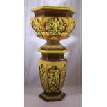 Doulton Lambeth majolica style jardiniere on stand decorated in relief with putti and scrolling