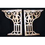 Pair of painted cast iron brackets, the spandrels with young male figure and swags,