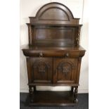 Victorian oak two door cabinet with gallery back top raised on twist supports,