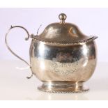 Mustard pot of ovoid shape with gadrooned edge and foot,